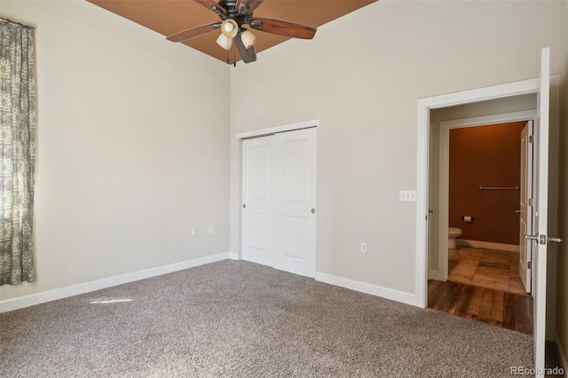 unfurnished bedroom featuring dark colored carpet and ceiling fan