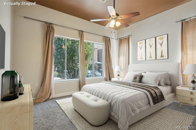 bedroom with ceiling fan, light colored carpet, and multiple windows