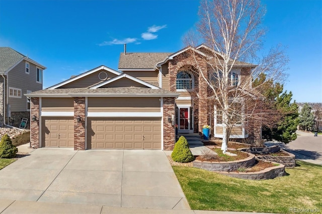 view of front of property featuring roof with shingles, driveway, a front lawn, brick siding, and a garage