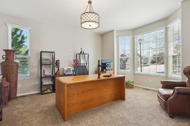 carpeted office with visible vents and baseboards