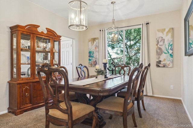 dining area featuring light carpet, an inviting chandelier, and baseboards