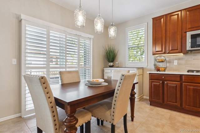dining space with light tile patterned floors and baseboards