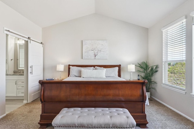 bedroom with baseboards, connected bathroom, light colored carpet, and vaulted ceiling