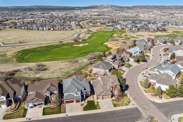birds eye view of property with view of golf course and a residential view