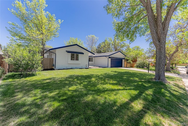 1486 S Kingston St, Aurora, CO 80012 - view of front of home featuring an attached garage, brick siding, and concrete driveway