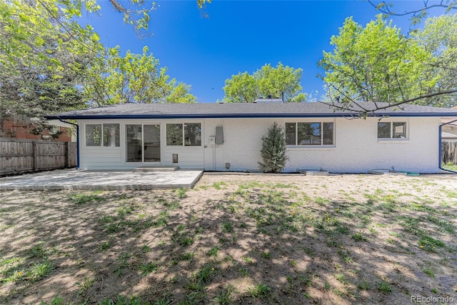1486 S Kingston St, Aurora, CO 80012 - back of property with brick siding and a patio