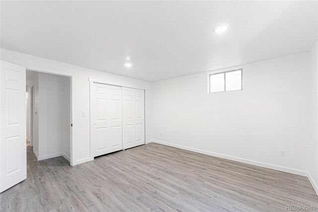 1486 S Kingston St, Aurora, CO 80012 - unfurnished bedroom with light wood-type flooring, baseboards, recessed lighting, and a closet