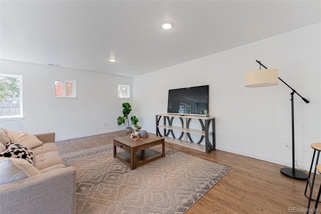 1486 S Kingston St, Aurora, CO 80012 - living room with wood finished floors, baseboards, and recessed lighting