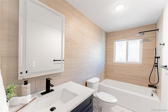1486 S Kingston St, Aurora, CO 80012 - bathroom with tile walls, toilet, vanity, backsplash, and tub / shower combination