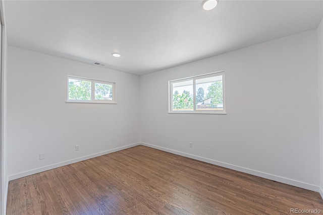 1486 S Kingston St, Aurora, CO 80012 - spare room featuring baseboards, wood finished floors, and recessed lighting