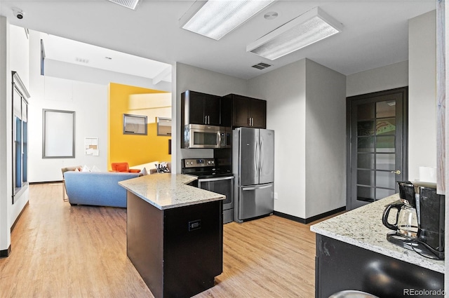 2154 Concord Ln, Superior, CO 80027 - kitchen with stainless steel appliances, light wood-type flooring, a peninsula, and baseboards