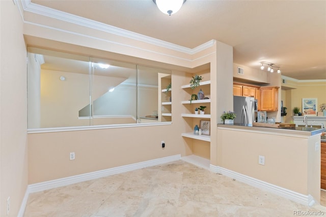 2154 Concord Ln, Superior, CO 80027 - kitchen featuring freestanding refrigerator, ornamental molding, a sink, a peninsula, and baseboards