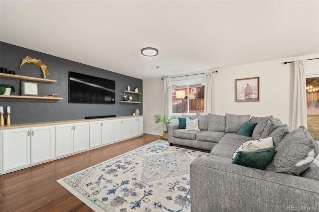 living room with baseboards and wood finished floors