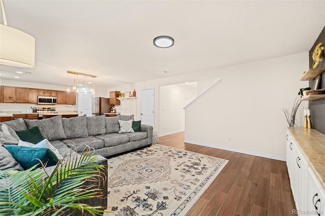 living room featuring dark wood finished floors and baseboards