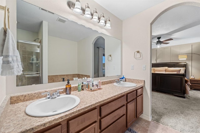 full bath featuring double vanity, visible vents, a shower stall, and a sink