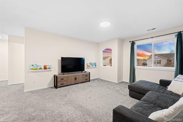 living room with visible vents, baseboards, and carpet floors