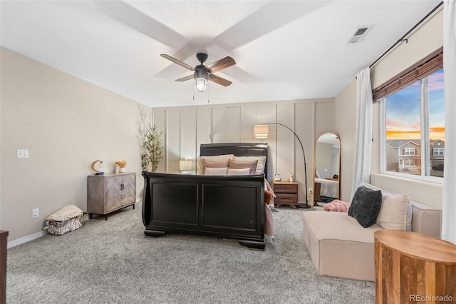 bedroom with visible vents, a ceiling fan, arched walkways, carpet flooring, and baseboards