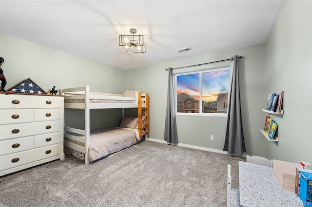 bedroom featuring baseboards, carpet, visible vents, and a textured ceiling