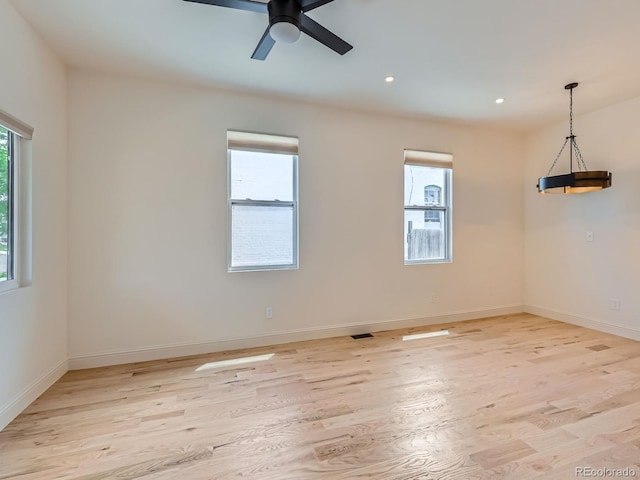 spare room with light wood finished floors, ceiling fan, baseboards, and recessed lighting