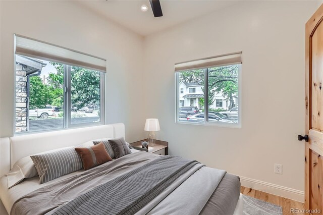 bedroom with multiple windows, baseboards, light wood finished floors, recessed lighting, and ceiling fan
