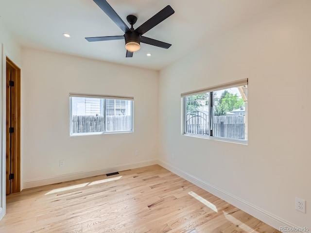 unfurnished room featuring healthy amount of natural light, light wood finished floors, a ceiling fan, baseboards, and recessed lighting