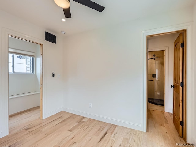 unfurnished room with light wood-style flooring, ceiling fan, and baseboards