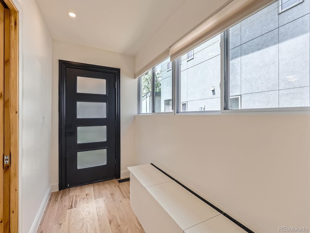 doorway with light wood-type flooring, recessed lighting, and baseboards