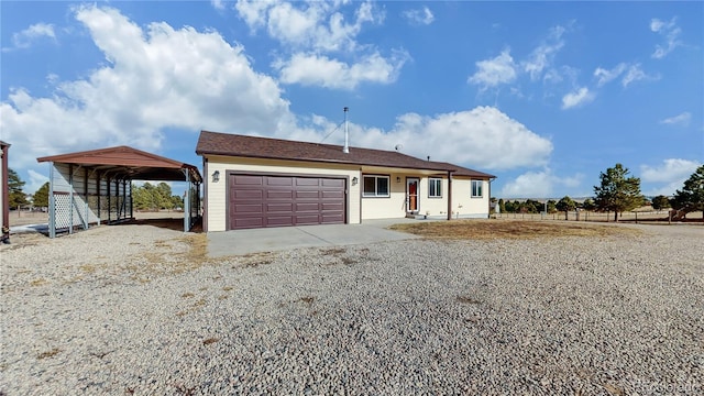 single story home with a carport, driveway, and a garage