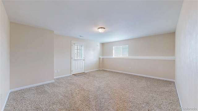 empty room with carpet flooring and baseboards