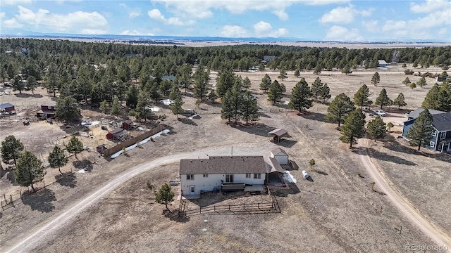 birds eye view of property featuring a wooded view