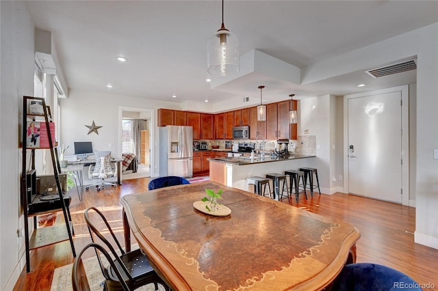 dining area with light hardwood / wood-style floors