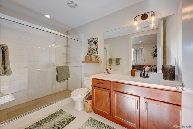 bathroom with a shower with door, vanity, and toilet