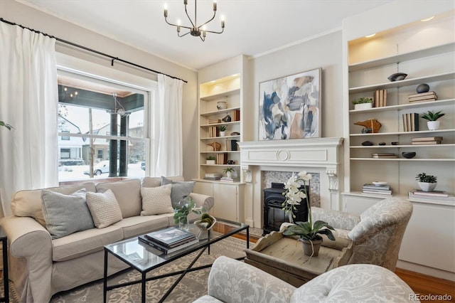 living room with hardwood / wood-style flooring, a notable chandelier, and built in shelves