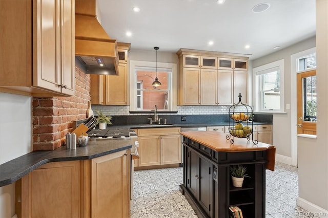 kitchen featuring sink, light brown cabinets, hanging light fixtures, light tile patterned floors, and custom exhaust hood