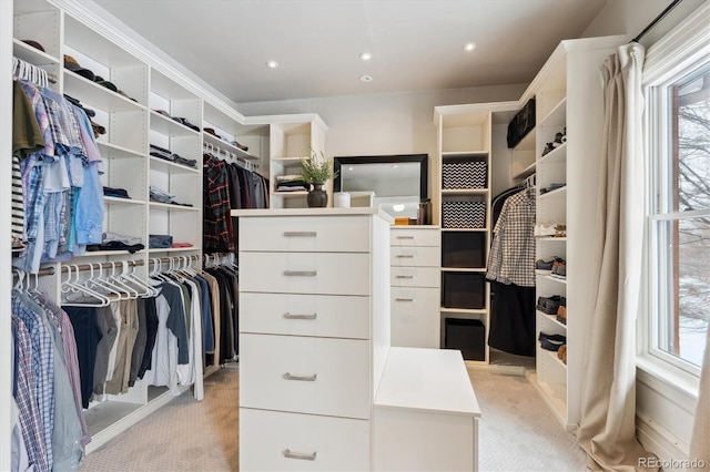 walk in closet featuring light colored carpet