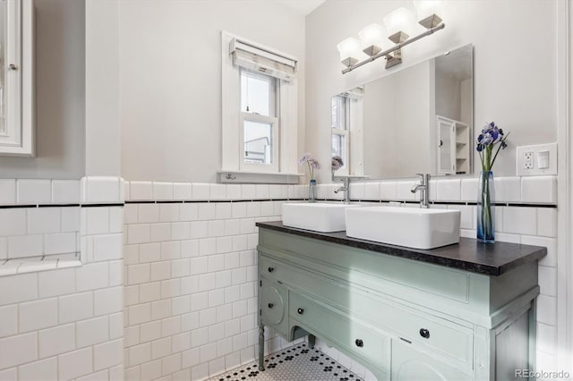 bathroom with vanity and tile walls