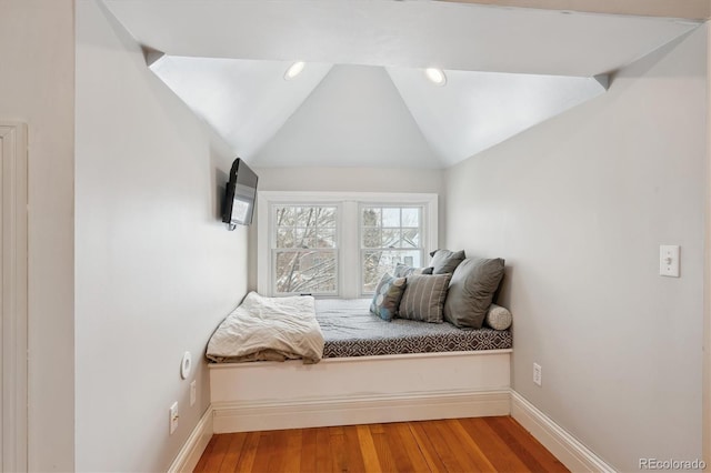 unfurnished bedroom featuring hardwood / wood-style floors and vaulted ceiling