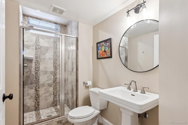 bathroom with toilet, an enclosed shower, and sink