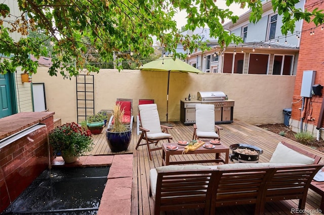 view of patio / terrace with a wooden deck and grilling area