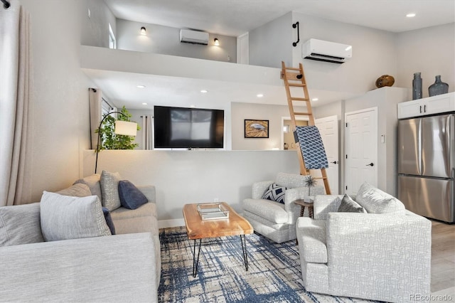 living room featuring light wood-type flooring, a towering ceiling, and a wall unit AC