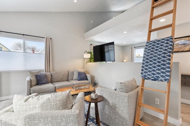 living room featuring vaulted ceiling and hardwood / wood-style flooring