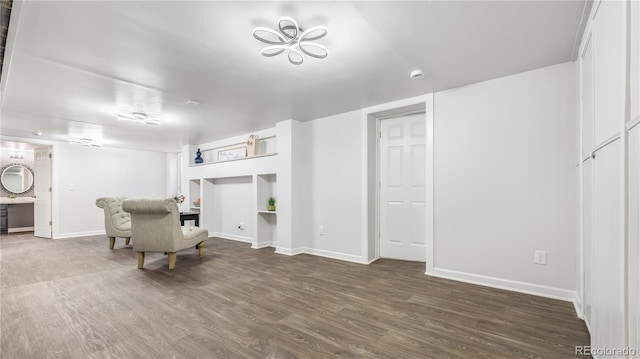 interior space with baseboards and wood finished floors