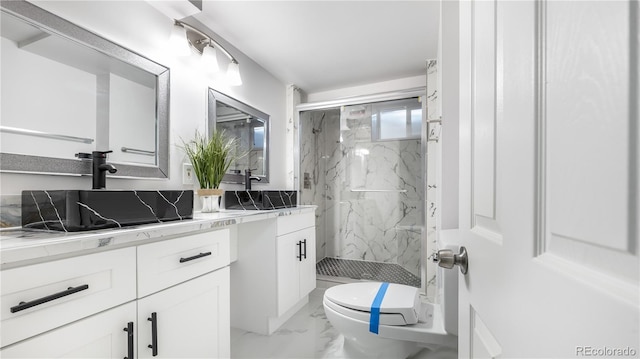 full bath featuring marble finish floor, vanity, a marble finish shower, and toilet