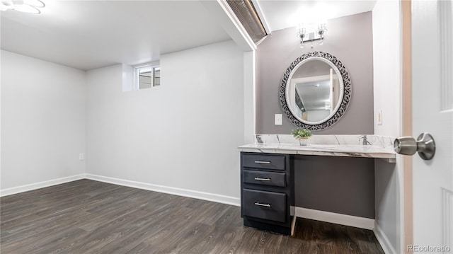 bathroom featuring wood finished floors, vanity, and baseboards