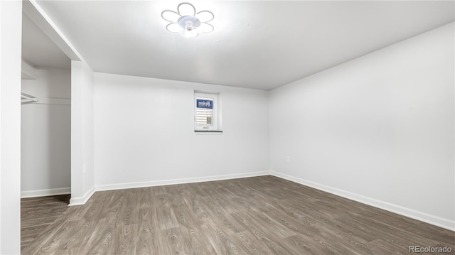 spare room with wood finished floors and baseboards