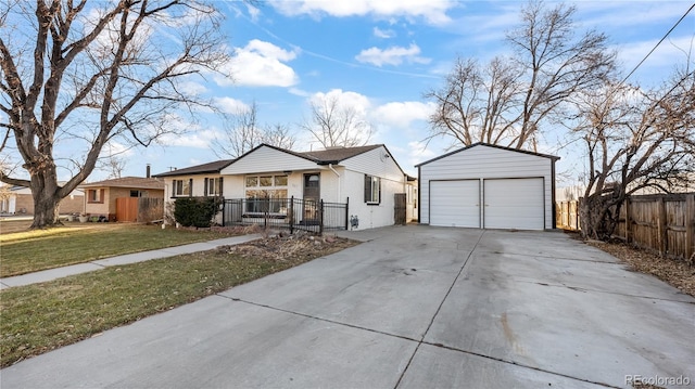 view of front of property featuring a garage, an outbuilding, fence, and a front yard