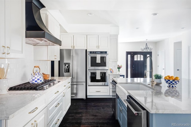 kitchen featuring tasteful backsplash, premium range hood, appliances with stainless steel finishes, and white cabinets