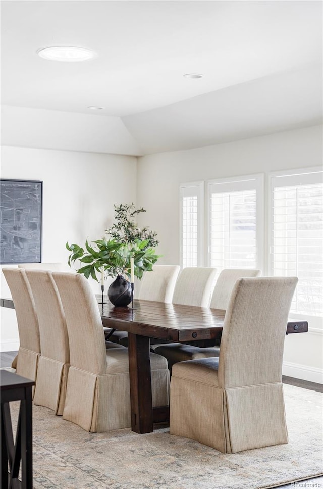 dining room with lofted ceiling and a wealth of natural light