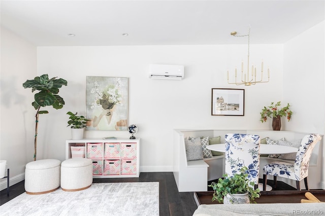 game room with a wall mounted air conditioner, a notable chandelier, and dark wood-type flooring