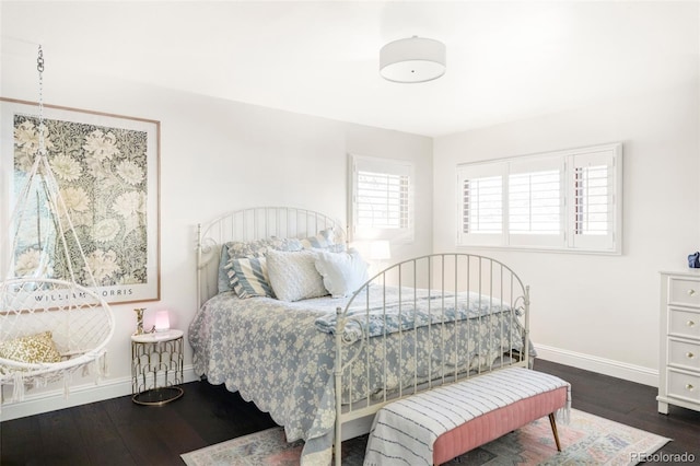 bedroom with dark hardwood / wood-style floors